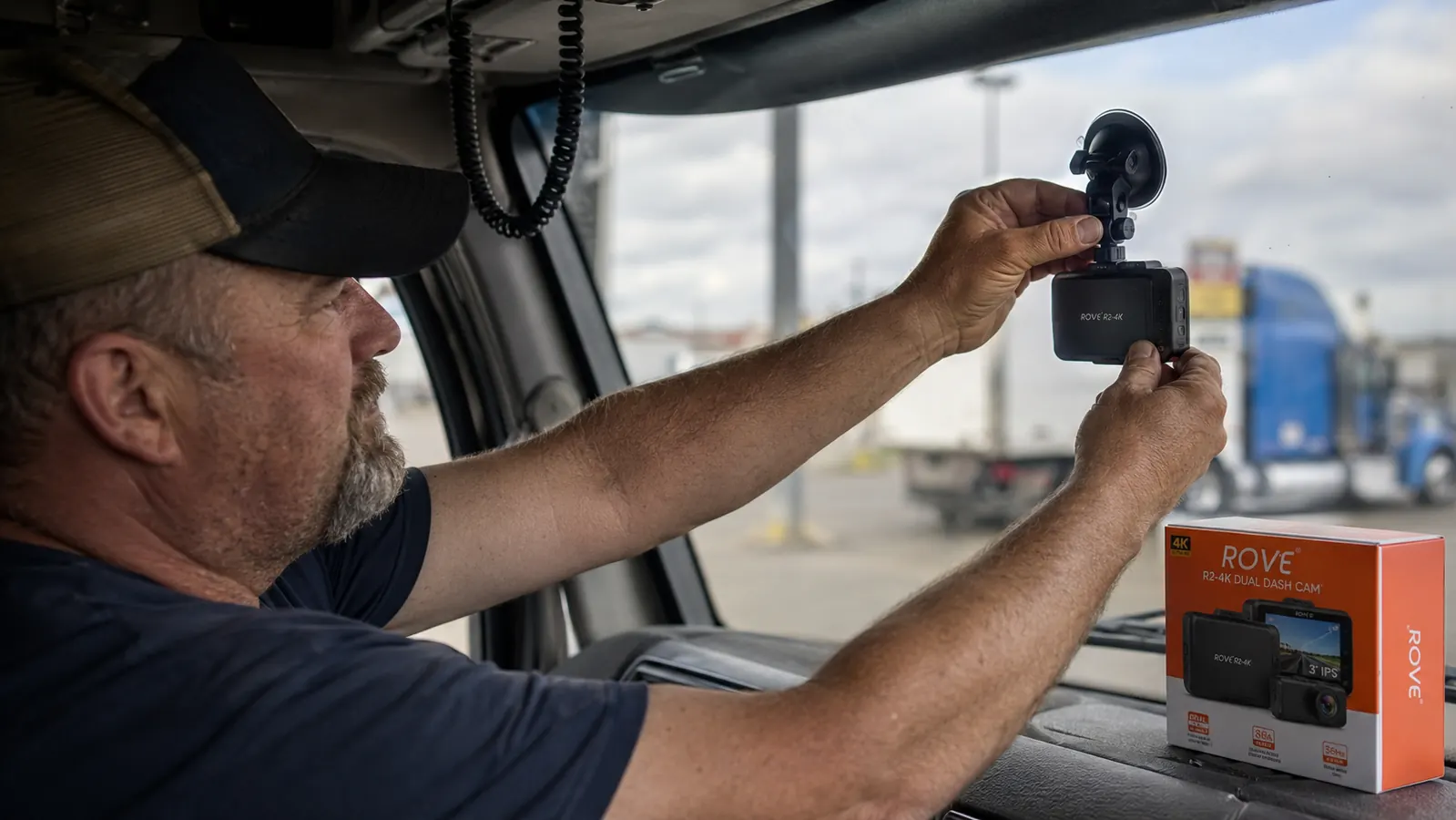 Close-up of a ROVE R2-4K dash cam mounted on a semi truck windshield with suction cup mount